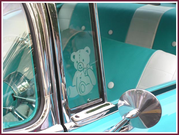 These cute Teddy Bears are etched into the vent windows of a 1957 Chevy Bel Air and compliement the color of the car perfectly!